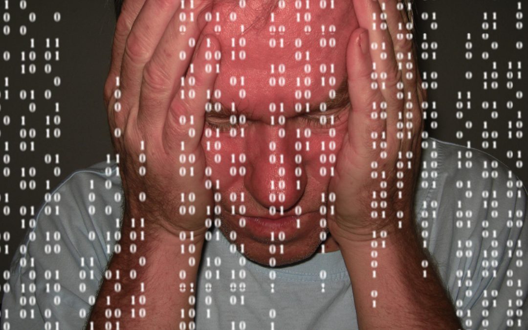 A man holds his face with a frustrated expression. Transparent computer code is overlayed on the image.